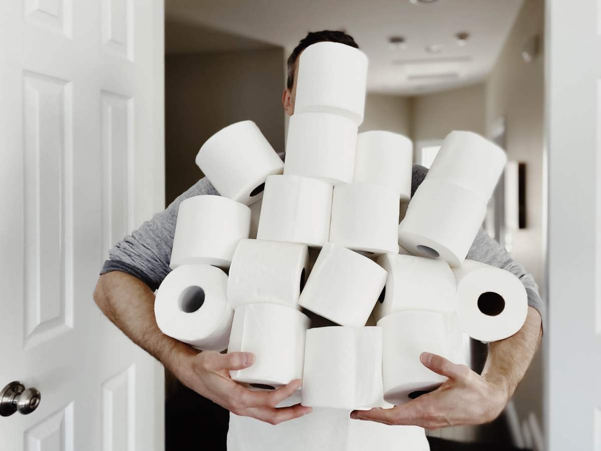 Close-up of man carrying an abundance of toilet paper
Getty Images | Photo by Grace Cary