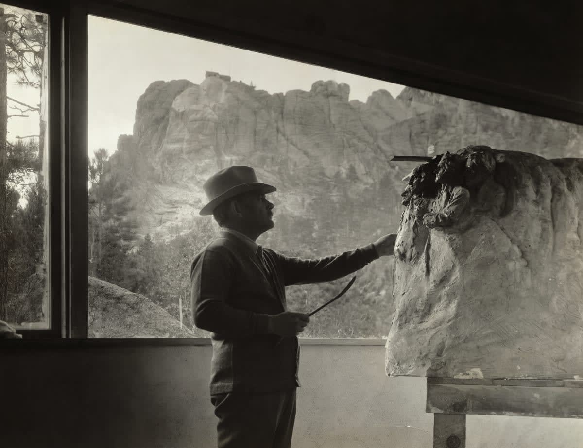 Image Source: (Original Caption) Gutzon Borglum (1867-1941), American sculptor at work, in his studio, on the model for Mt. Rushmore. Photograph, ca. 1930s. (Photo by George Rinhart/Corbis via Getty Images)