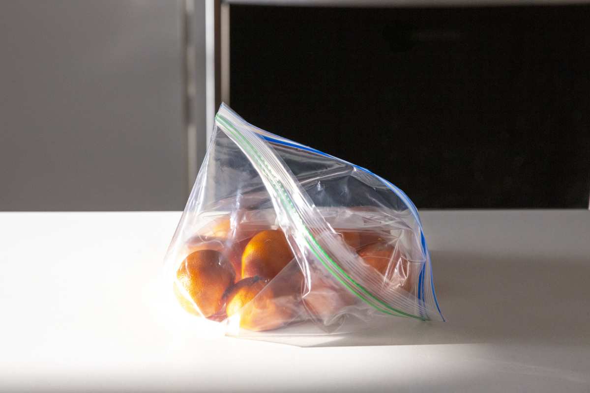 Oranges in single-use plastic bag on kitchen counter. Getty Images | Photo by Jena Ardell