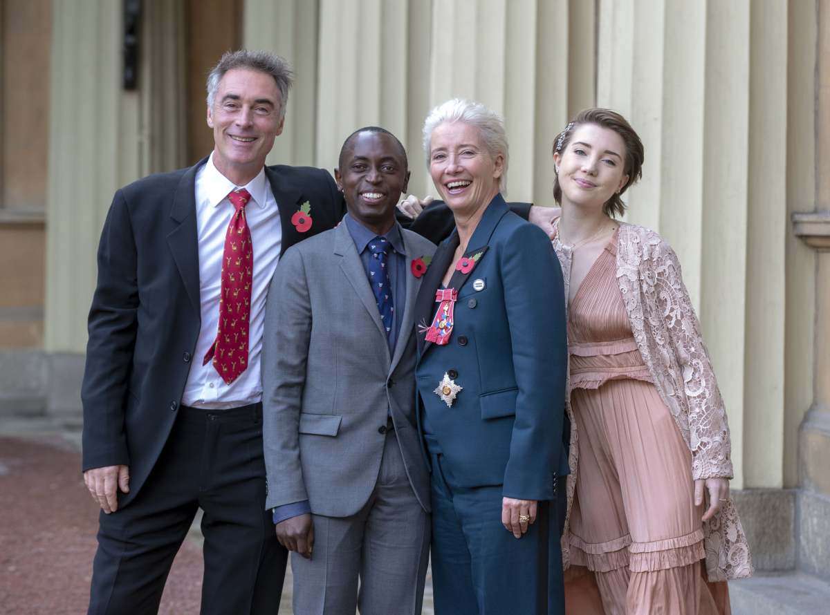 Image Source: Actress Emma Thompson, with her husband Greg Wise and children Gaia Wise and Tindy Agaba, leaves Buckingham Palace after she received her damehood at an Investiture ceremony on November 7, 2018 in London, England. Ms Thompson, 59, received the accolade in recognition of her services to drama. (Photo by Steve Parsons - WPA Pool/Getty Images)