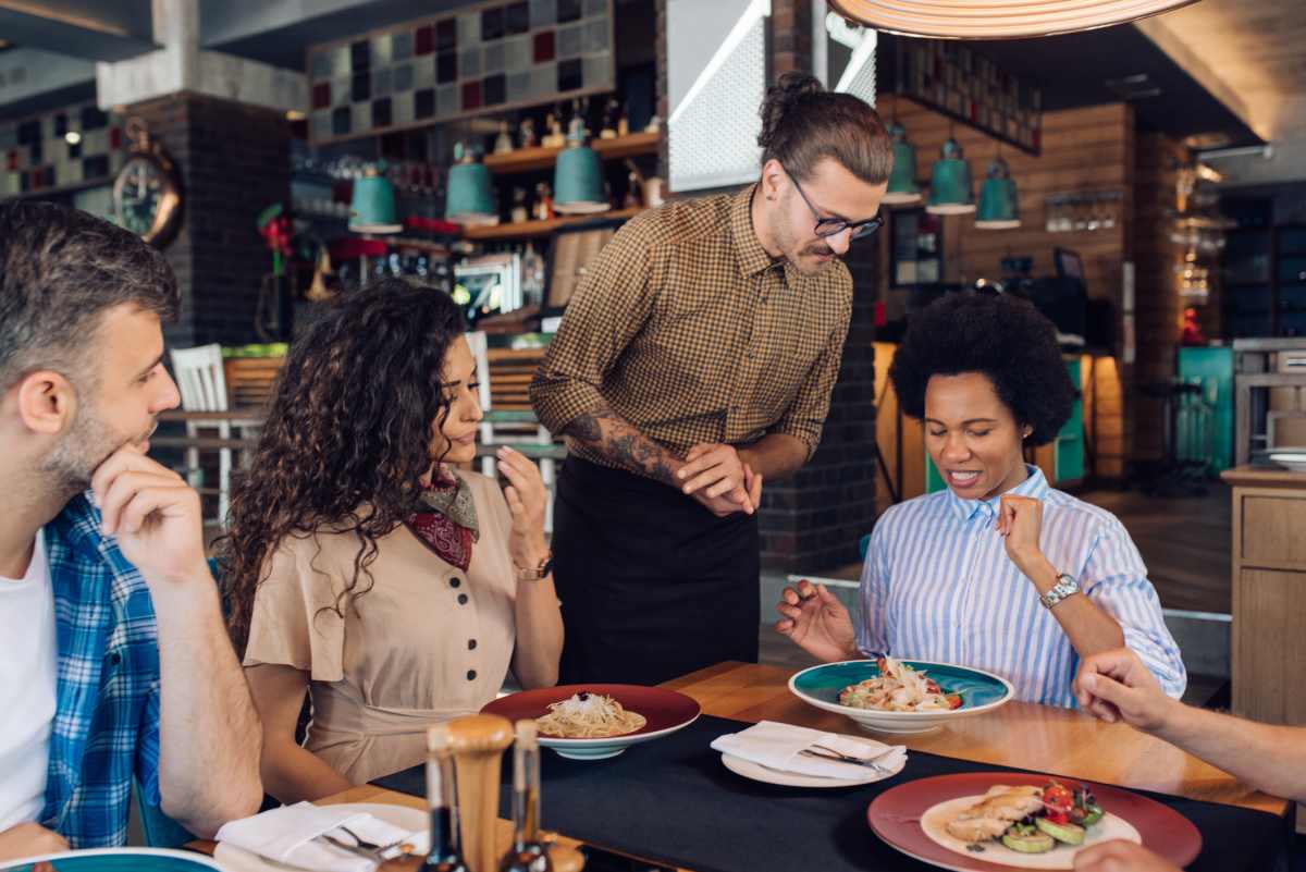 Group of colleagues having a business lunch at the restaurant. (Representative Image Source: Getty Images | Photo by Rgstudio)