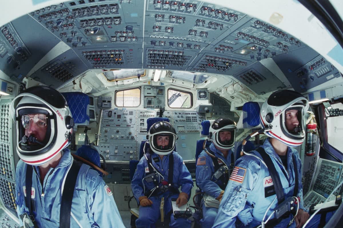 Image Source: our of the astronauts selected for the Space Shuttle Challenger mission in 1986 sit in the shuttle mission simulator (SMS). From left they are, Michael J. Smith, Ellison S. Onizuka, Judith A. Resnik, and Francis R. (Dick) Scobee. (Photo by Bill Bowers/Corbis/VCG via Getty Images)