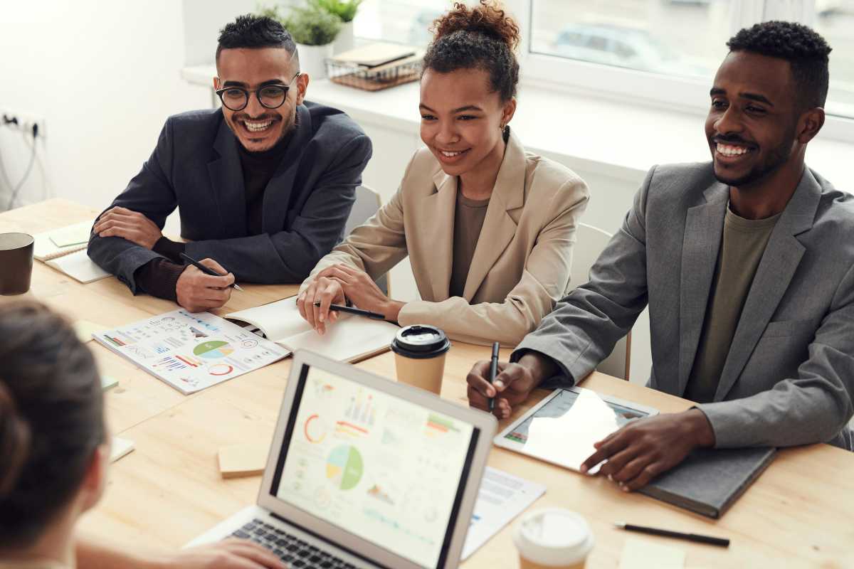 Picture shows happy employees during a board meeting. (Representative Image Source: Pexels | fauxels)